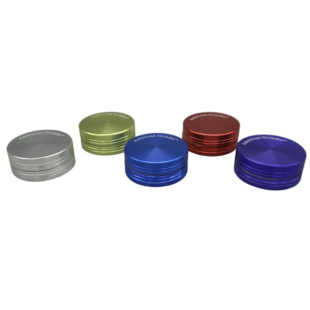 Set of five metal grinders in different colors on a white background